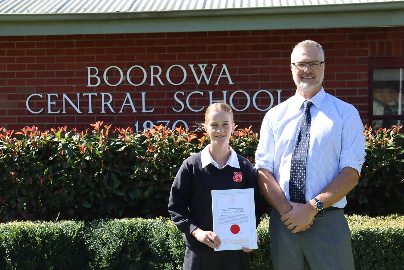 Mylee with the certificate she received from Steph Cooke MP and Boorowa Central School principal Graham Jones.