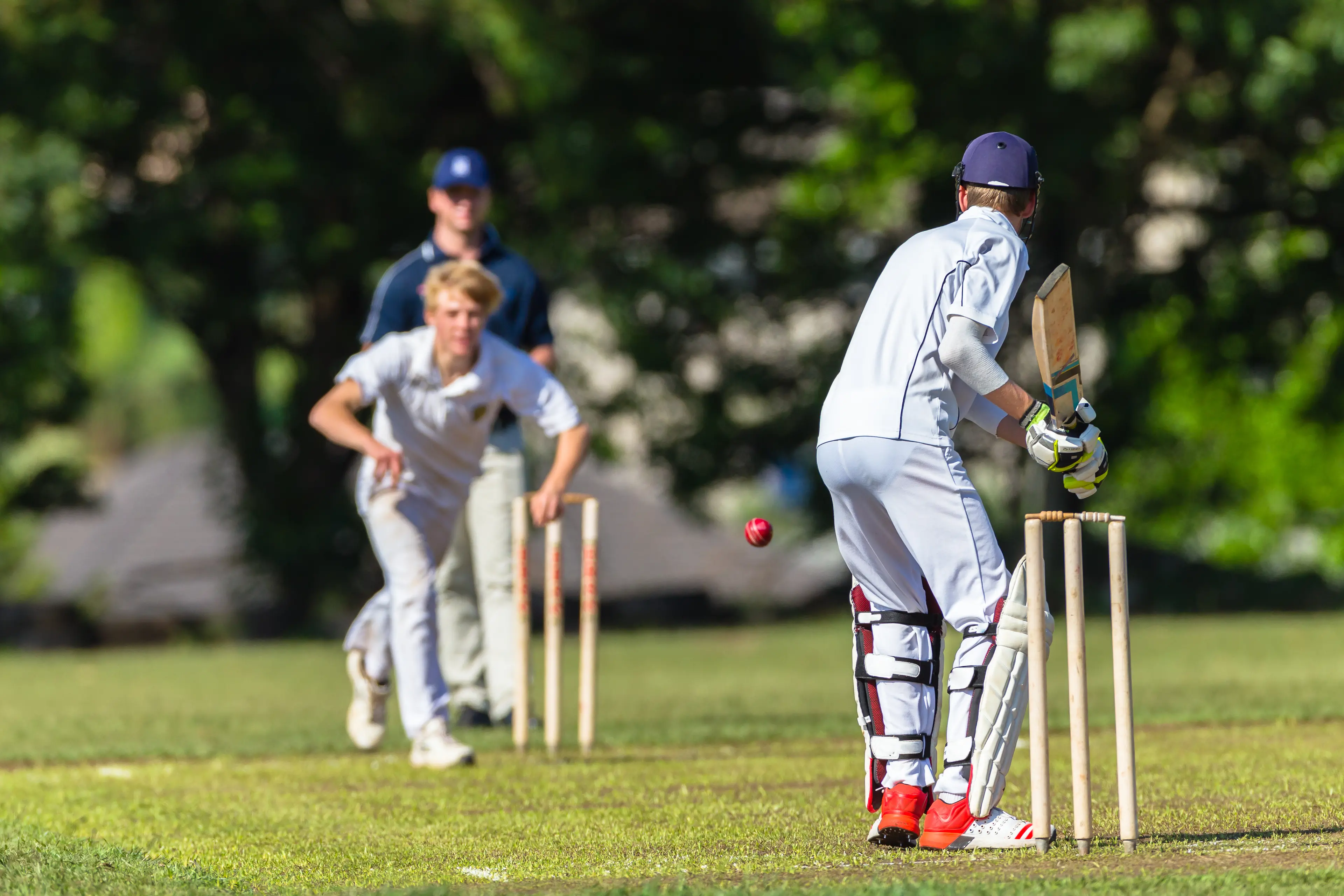 <p>Cricket game teenagers schools game batsman bowler action photo.</p>\\n