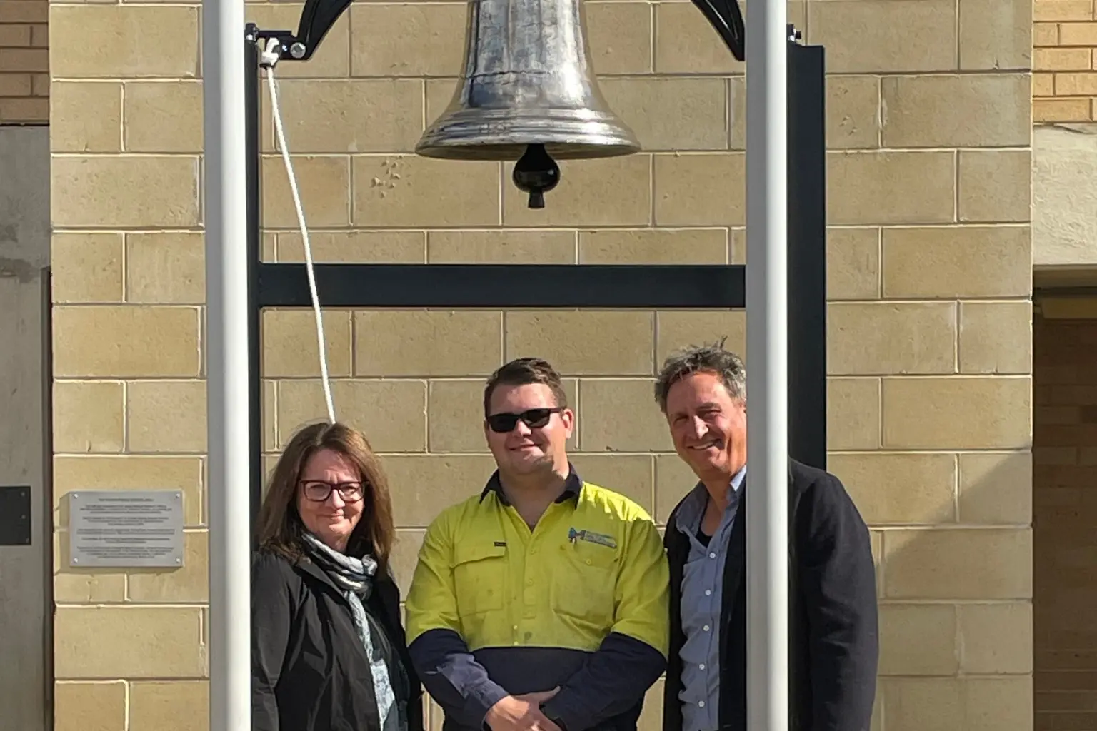 <p>From left, Edwina Mason, Josh Rendell and Jamie Watson beneath Young Public School\\u2019s restored 152-year-old bell following its unveiling.</p>\\n