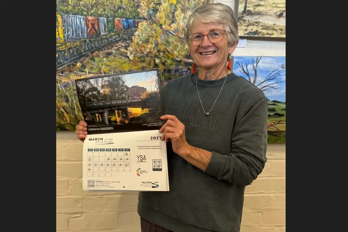 <p>Young Society of Artists member Heather Ruhl showcases the 2027 A Year in the Hilltops calendar at the Young Show. Proceeds from calendar sales will support the 2027 Hilltops Off The Beaten Track Arts & Cultural Trail.</p>\\n
